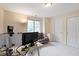 Brightly lit bedroom with a window, desk with monitors, and a white door at 9175 Lakewind Dr, Indianapolis, IN 46256