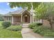 Inviting front entrance featuring a red door, classic columns, and landscaped garden at 9175 Lakewind Dr, Indianapolis, IN 46256