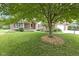 Well-maintained front yard showcases mature trees and landscaping, enhancing the curb appeal at 9175 Lakewind Dr, Indianapolis, IN 46256