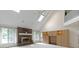 Open-concept living room boasts a fireplace, built-in cabinets, and large windows at 9175 Lakewind Dr, Indianapolis, IN 46256