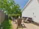 Brick backyard patio featuring outdoor seating amidst lush green foliage, perfect for entertaining and relaxation at 9635 Shasta Dr, Fishers, IN 46038