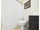 Bathroom view featuring a toilet next to a cabinet and a shower with a curtain at 9635 Shasta Dr, Fishers, IN 46038