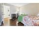 Bedroom with hardwood floors, a decorative bed frame, and a beverage cooler at 9635 Shasta Dr, Fishers, IN 46038