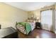 Cozy bedroom with hardwood floors, a decorative bed frame and bedside table with lamp at 9635 Shasta Dr, Fishers, IN 46038