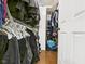 Walk-in closet featuring wire shelving, hanging clothes and a hardwood floor at 9635 Shasta Dr, Fishers, IN 46038