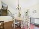 Charming dining area with hardwood floors, chandelier lighting, and staircase, ideal for Gathering meals and entertaining at 9635 Shasta Dr, Fishers, IN 46038