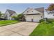 Charming two-story home boasts a two-car garage, complemented by a well-maintained lawn and landscape at 9635 Shasta Dr, Fishers, IN 46038