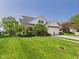 Beautiful two-story home with a lush green lawn, mature trees, and a convenient two-car garage at 9635 Shasta Dr, Fishers, IN 46038