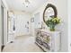 Bright entryway featuring a decorative dresser, an ornate mirror, and a glimpse of the sunlit front door at 9635 Shasta Dr, Fishers, IN 46038