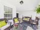 Charming front porch with wicker seating, bright pillows, and a decorative rug, creating a cozy outdoor space at 9635 Shasta Dr, Fishers, IN 46038