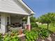 Inviting front porch showcasing comfortable seating, lush plants, and a relaxing swing, perfect for outdoor enjoyment at 9635 Shasta Dr, Fishers, IN 46038