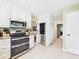 A kitchen with white cabinets, stainless steel appliances, and tile flooring, perfect for cooking and entertaining at 9635 Shasta Dr, Fishers, IN 46038