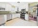 Well-lit kitchen with white cabinets, stainless steel appliances, and ample counter space for meal preparation at 9635 Shasta Dr, Fishers, IN 46038
