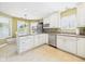Bright and airy kitchen featuring white cabinetry, stainless steel appliances, and an adjacent breakfast nook at 9635 Shasta Dr, Fishers, IN 46038