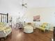 Open-concept living area with hardwood floors, comfortable seating, and a ceiling fan, perfect for Gathering gatherings at 9635 Shasta Dr, Fishers, IN 46038