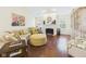 A sunlit living room with hardwood floors, a cozy fireplace, and comfortable seating, ideal for relaxation at 9635 Shasta Dr, Fishers, IN 46038