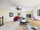 Cozy living room featuring carpet flooring, comfortable seating, and a stylish ceiling fan, creating an inviting space at 9635 Shasta Dr, Fishers, IN 46038