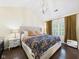 Well-lit main bedroom with hardwood floors, a queen bed, and ample natural light for a cozy retreat at 9635 Shasta Dr, Fishers, IN 46038