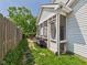 Charming screened-in porch with white siding and a view of the green yard and partial wood fence at 9635 Shasta Dr, Fishers, IN 46038