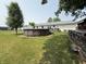 Expansive backyard with an above-ground pool, grassy lawn, and wooden fence with chicken coop at 106 9Th St, New Market, IN 47965