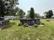 A large backyard featuring an above-ground pool surrounded by lush grass and mature trees at 106 9Th St, New Market, IN 47965