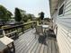 Relaxing deck features a glass top table and seating surrounded by lush greenery and ample space at 106 9Th St, New Market, IN 47965