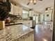 Bright kitchen features white cabinets, granite countertops, and stainless steel appliances at 106 9Th St, New Market, IN 47965