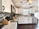 Bright kitchen with white cabinets, granite countertops, and stainless steel appliances at 106 9Th St, New Market, IN 47965