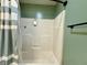 Clean shower with a white bathtub and striped shower curtain at 106 9Th St, New Market, IN 47965
