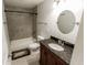Updated bathroom features tub-shower, dark granite vanity, and tile flooring at 110 Highland Ave, Franklin, IN 46131