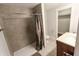 This bathroom has modern shower with marble surround, sink and a toilet in a well lit space at 110 Highland Ave, Franklin, IN 46131