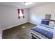 Cozy bedroom with carpeted floors, a comfortable bed, and a window providing natural light at 110 Highland Ave, Franklin, IN 46131