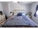 This primary bedroom features neutral walls, plush carpet, a white bed frame and a window at 110 Highland Ave, Franklin, IN 46131
