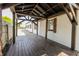 View of covered deck with stained wood floor at 110 Highland Ave, Franklin, IN 46131
