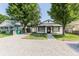 Charming single-story home with covered parking and a gravel driveway lined with timber at 110 Highland Ave, Franklin, IN 46131