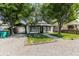 Charming single-story home with covered parking and a gravel driveway lined with timber at 110 Highland Ave, Franklin, IN 46131
