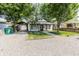Charming single-story home with covered parking and a gravel driveway lined with timber at 110 Highland Ave, Franklin, IN 46131
