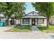 Charming single-story home with covered parking and a gravel driveway lined with timber at 110 Highland Ave, Franklin, IN 46131