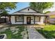 Inviting single-story home with a gravel path, showcasing its covered front porch and dark window shutters at 110 Highland Ave, Franklin, IN 46131