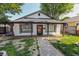 Inviting single-story home with a gravel path, showcasing its covered front porch and dark window shutters at 110 Highland Ave, Franklin, IN 46131
