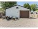 A detached one-car garage with neutral paint stands on a gravel driveway at 110 Highland Ave, Franklin, IN 46131