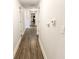 Hallway with wood-look flooring, white walls, and doors leading to various rooms in the home at 110 Highland Ave, Franklin, IN 46131