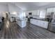 Bright kitchen with white cabinets, stainless steel appliances, and a center island with dark countertops at 110 Highland Ave, Franklin, IN 46131