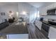 Modern kitchen featuring stainless steel appliances, white cabinets, dark countertops and a kitchen island at 110 Highland Ave, Franklin, IN 46131