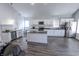 Modern kitchen featuring white cabinets, stainless steel appliances, and a dark countertop island at 110 Highland Ave, Franklin, IN 46131