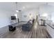 Bright and airy living room with gray wood floors, a ceiling fan, and a modern kitchen at 110 Highland Ave, Franklin, IN 46131
