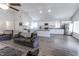 Open-concept living room with modern kitchen, ceiling fan, and comfortable seating arrangement at 110 Highland Ave, Franklin, IN 46131