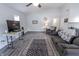 Spacious living area with grey wood flooring, modern decor, and a view of the kitchen at 110 Highland Ave, Franklin, IN 46131