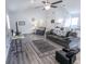 Well-lit living room with ceiling fan, comfortable seating, and a view into the adjacent kitchen at 110 Highland Ave, Franklin, IN 46131