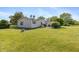 Spacious backyard with lush green lawn, mature trees and a patio area, ideal for outdoor activities at 1114 E 234Th St, Sheridan, IN 46069